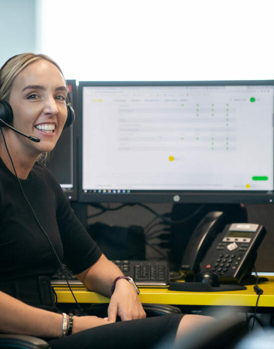 alt="Lemon Contact Centre operator smiling looking at camera wearing heatset"