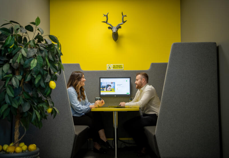 alt="male and female having a meeting at Lemon Contact Centre"